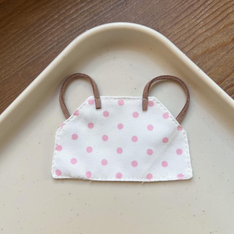 White apron with pink dots